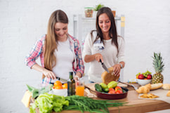 Two girls preparing a healthy, nutritious meal.